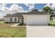 Newly constructed one-story home with a two-car garage and landscaped front yard at 3623 Giblin Dr, North Port, FL 34286