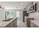 Modern kitchen with gray cabinets, quartz countertops and stainless steel appliances at 3623 Giblin Dr, North Port, FL 34286