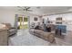 Living room with reclining sofa and view of kitchen and backyard at 3623 Giblin Dr, North Port, FL 34286