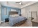 Spacious main bedroom with a king-size bed and blue accent wall at 3623 Giblin Dr, North Port, FL 34286