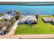 Bird's eye view of waterfront home with lush lawn and private dock at 3662 Peace River Dr, Punta Gorda, FL 33983