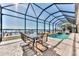 Enclosed patio with pool and seating area overlooking the water at 3662 Peace River Dr, Punta Gorda, FL 33983