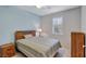 Cozy bedroom with wood furniture, ceiling fan, and window shutters at 3766 82Nd Avenue E Cir # 106, Sarasota, FL 34243