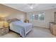 Bright bedroom with double bed, nightstand and window shutters at 3766 82Nd Avenue E Cir # 106, Sarasota, FL 34243