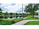 Serene lakefront view with walking path at 3766 82Nd Avenue E Cir # 106, Sarasota, FL 34243