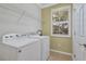 Laundry room with Whirlpool washer and dryer and ample shelving at 3766 82Nd Avenue E Cir # 106, Sarasota, FL 34243