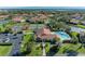 Aerial view of community pool, tennis courts, and parking area at 3803 Wilshire W Cir # 37, Sarasota, FL 34238