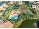 Community pool, tennis courts, and parking from above at 3803 Wilshire W Cir # 37, Sarasota, FL 34238