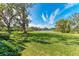 Serene backyard with lush lawn and peaceful lake view at 3803 Wilshire W Cir # 37, Sarasota, FL 34238