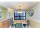 Dining area with wood table and four green velvet chairs near window at 3803 Wilshire W Cir # 37, Sarasota, FL 34238