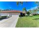 Front view of a house with a two-car garage and manicured lawn at 3803 Wilshire W Cir # 37, Sarasota, FL 34238