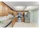 Modern kitchen with stainless steel appliances and wood cabinets at 3803 Wilshire W Cir # 37, Sarasota, FL 34238