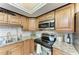 View of kitchen corner with granite countertops and stainless steel appliances at 3803 Wilshire W Cir # 37, Sarasota, FL 34238