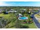 Community pool with lush landscaping at 3803 Wilshire W Cir # 37, Sarasota, FL 34238