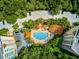 Aerial view of community pool, building, and parking at 385 N Point Rd # 402, Osprey, FL 34229