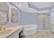 Elegant bathroom with a soaking tub and glass shower at 385 N Point Rd # 402, Osprey, FL 34229