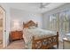 Bright bedroom with wood-framed bed, window shutters, and tiled floor at 385 N Point Rd # 402, Osprey, FL 34229