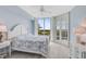 Main bedroom with white furniture and water views at 385 N Point Rd # 402, Osprey, FL 34229