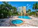 Community pool and hot tub with lounge chairs at 385 N Point Rd # 402, Osprey, FL 34229