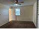 Bedroom with ceiling fan, carpet, and access to bath at 3875 59Th W Ave # 3875, Bradenton, FL 34210