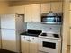 Kitchen with white cabinets, black countertops, and appliances at 3875 59Th W Ave # 3875, Bradenton, FL 34210