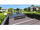 Community deck overlooking a lake with a bench at 3875 59Th W Ave # 3875, Bradenton, FL 34210