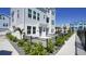 Gray paved pathway beside a light blue home with a black fence and landscaping at 407 Gowdy Rd, Sarasota, FL 34237