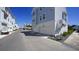 Street view of light blue townhomes with a paved road and landscaping at 407 Gowdy Rd, Sarasota, FL 34237