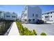 Side view of a light blue home with a gray paved parking area and landscaping at 407 Gowdy Rd, Sarasota, FL 34237