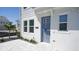 Modern front entrance with a blue door and paved walkway at 407 Gowdy Rd, Sarasota, FL 34237