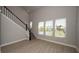 Bright living room with large windows, hardwood floors and a modern staircase at 407 Gowdy Rd, Sarasota, FL 34237