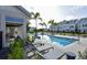 Resort-style pool with lounge chairs, cabana, and surrounding landscaping at 407 Gowdy Rd, Sarasota, FL 34237