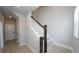 Modern light gray staircase with dark wood railings and light wood flooring at 407 Gowdy Rd, Sarasota, FL 34237