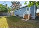 Rear view of house; light blue siding, steps, and fenced yard at 412 30Th E St, Palmetto, FL 34221