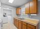 Kitchen features wood cabinets, double sink, and laundry access at 412 30Th E St, Palmetto, FL 34221