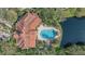 Aerial view of community pool, clubhouse, and lake at 4166 Central Sarasota Pkwy # 515, Sarasota, FL 34238