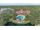 Community pool and clubhouse with lush landscaping at 4166 Central Sarasota Pkwy # 515, Sarasota, FL 34238