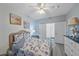 Guest bedroom with a coastal-themed bedspread and ensuite bathroom at 4166 Central Sarasota Pkwy # 515, Sarasota, FL 34238