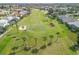 Aerial view of a lush green golf course with palm trees at 4221 Augusta E Ter, Bradenton, FL 34203