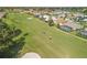 Aerial view of golf course with houses and golf carts at 4221 Augusta E Ter, Bradenton, FL 34203