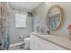 Charming bathroom with white vanity and oval mirror at 4221 Augusta E Ter, Bradenton, FL 34203