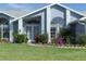 Front entrance with landscaping and a screen door at 4221 Augusta E Ter, Bradenton, FL 34203