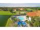 Community pool with lounge chairs and shade umbrellas at 4221 Augusta E Ter, Bradenton, FL 34203