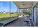 Serene screened porch with view of a green golf course at 4221 Augusta E Ter, Bradenton, FL 34203