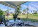 Spacious screened porch with table and chairs, overlooking a golf course at 4221 Augusta E Ter, Bradenton, FL 34203