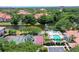 Aerial view of community pool, tennis court, and landscaping at 4264 Central Sarasota Pkwy # 122, Sarasota, FL 34238