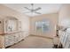 Well-lit bedroom featuring a dresser, nightstands, and a ceiling fan at 4264 Central Sarasota Pkwy # 122, Sarasota, FL 34238