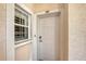 Condo entryway with white door and window featuring keyless entry at 4264 Central Sarasota Pkwy # 122, Sarasota, FL 34238