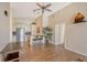 Open living area with wood-look tile floors and kitchen access at 4264 Central Sarasota Pkwy # 122, Sarasota, FL 34238