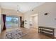 Living room with wood-look floors, sliding glass doors, and ceiling fan at 4264 Central Sarasota Pkwy # 122, Sarasota, FL 34238